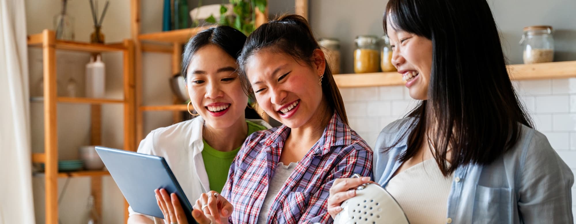 Happy beautiful chinese women friends bonding at home and cooking delicious meal together- Playful asian female adults meeting and having fun at home, concepts about domestic life and friendship