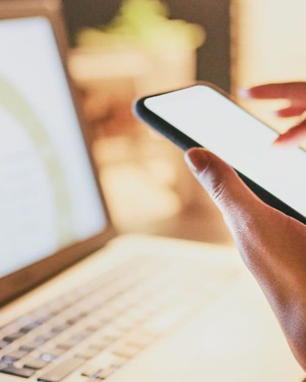 businesswoman use her mobile phone and laptop to search content