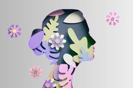 International Womens Day poster with woman silhouette and floral ornaments in paper cut 3D illustration